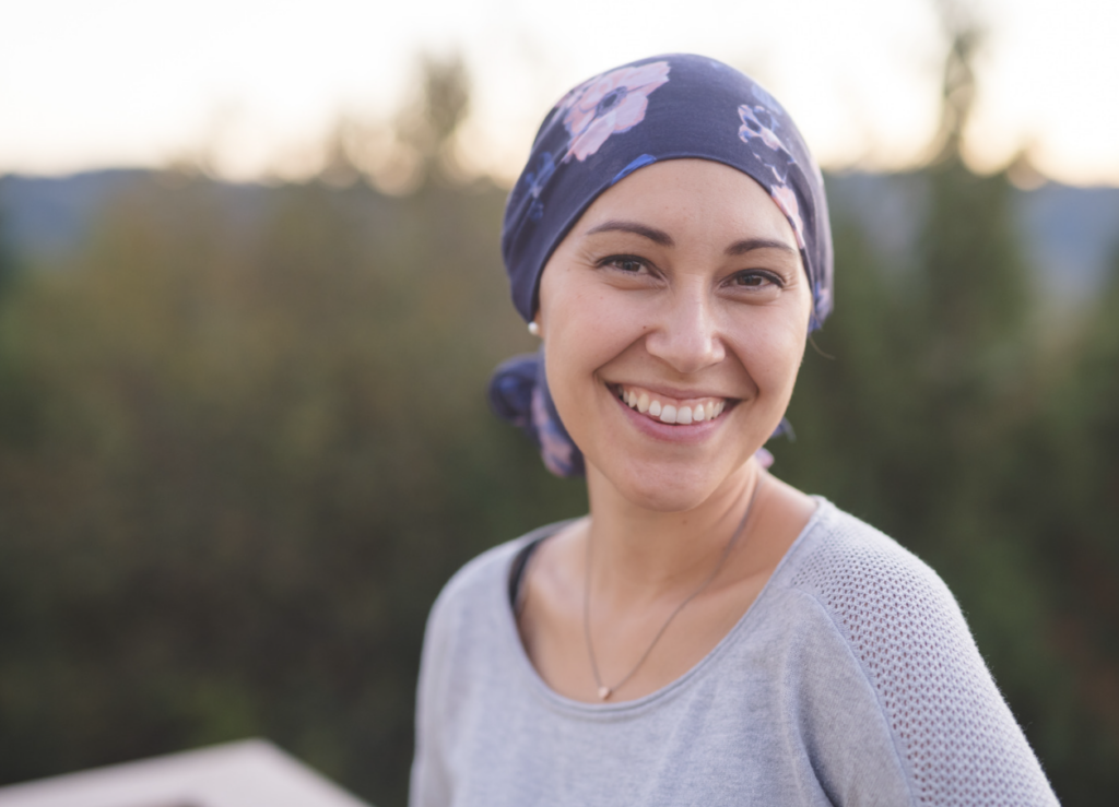 a WOMEN with cancer that has a scarf around her head. 